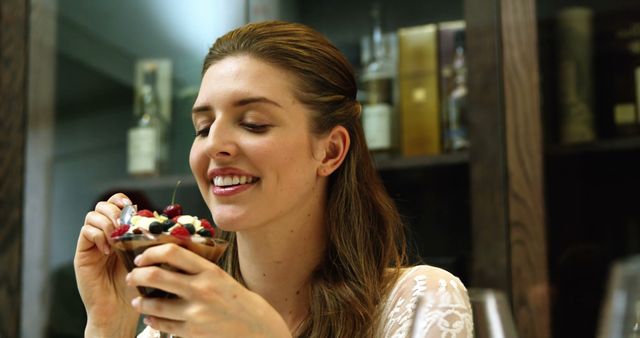 Smiling Woman Enjoying Sweet Dessert in Cozy Home Setting - Download Free Stock Images Pikwizard.com