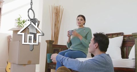 Couple enjoys new home with house key symbolizing ownership