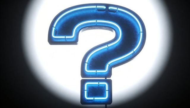 Glowing blue neon question mark sign emitting halo spotlight glow for faq and mystery