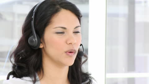 Smiling Businesswoman Wearing Headset at Call Center