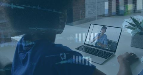 Clinician in blue scrubs consulting via laptop with digital data overlay for telemedicine