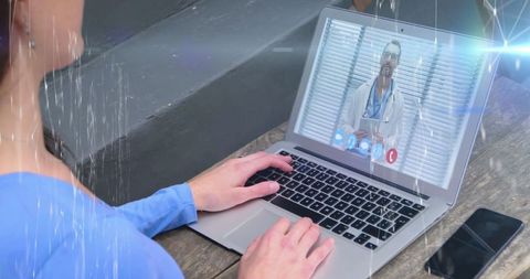 Woman engaging in telemedicine consultation on laptop at home