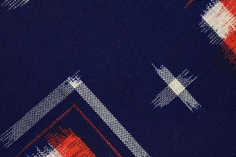 Navy canvas textile with distressed white and red brushstroke plaid pattern