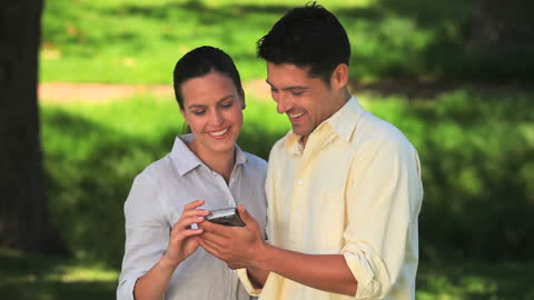 Couple Enjoying a Day in Park Taking Selfie