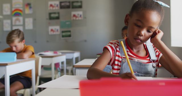 Focused African-American Girl Writing in Classroom - Download Free Stock Images Pikwizard.com