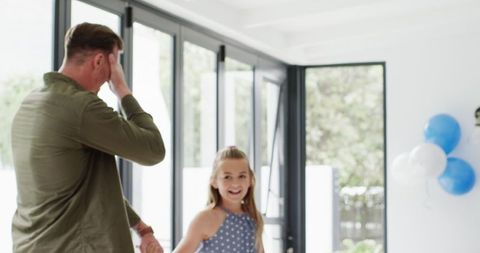 Family Celebrating Daughter's Birthday in Bright Living Room