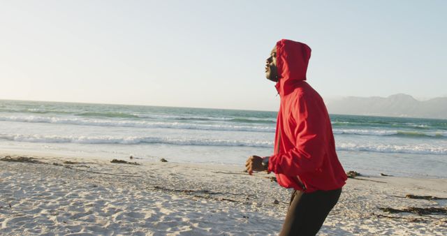 Man Wearing Red Hoodie Running on Beach at Sunrise - Download Free Stock Images Pikwizard.com