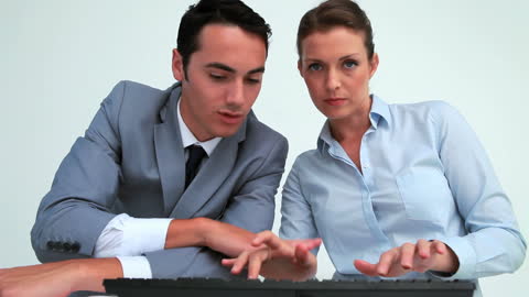 Business Team Collaborating on Computer in Office