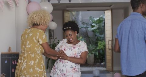 Joyful Friends Celebrating Indoors with Festive Excitement