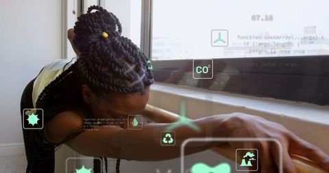 Stretching woman by window with braided bun and holographic sustainability icons