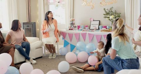 Diverse Group Celebrating Baby Shower in Festive Setting