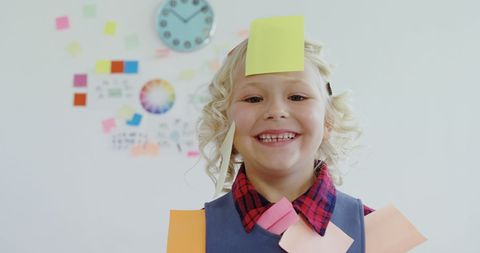 Cheerful Child Covered in Sticky Notes in Office Environment