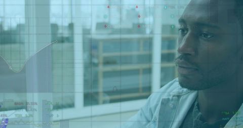 African American Business Analyst Reviewing Data in Modern Office