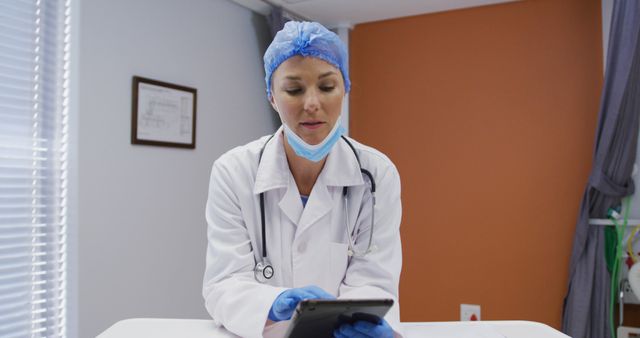 Female Doctor in Lab Coat Using a Tablet in Hospital Room - Download Free Stock Images Pikwizard.com