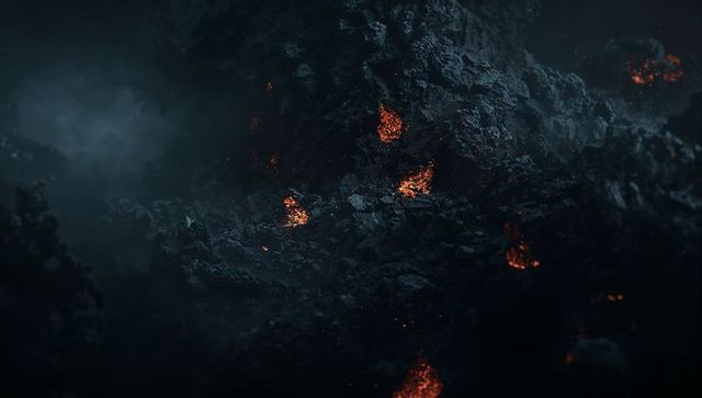 Glowing lava embers amidst rugged volcanic rocks at night