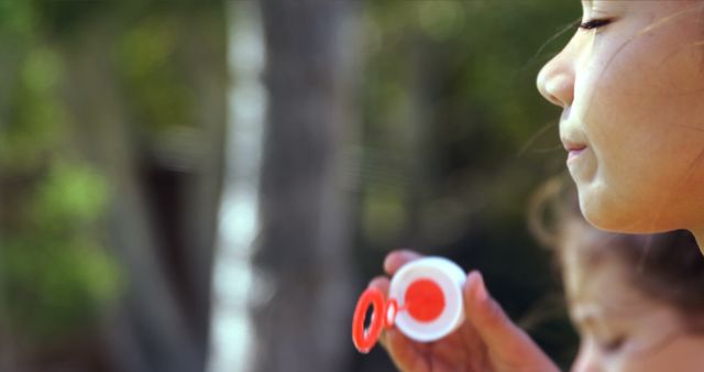 Child Blowing Bubbles Outdoors in Sunny Garden - Download Free Stock Images Pikwizard.com