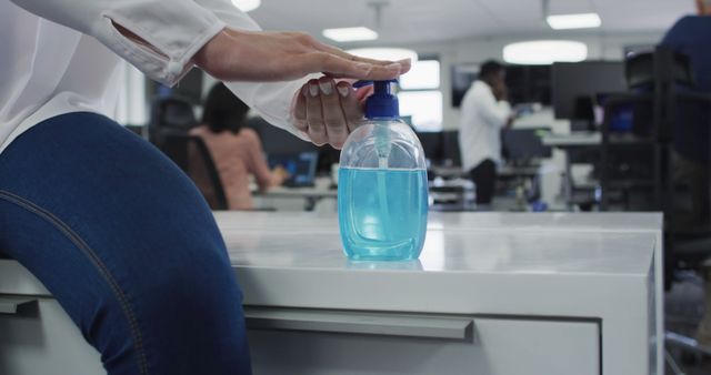 Close-up Person Using Hand Sanitizer in Modern Office - Download Free Stock Images Pikwizard.com