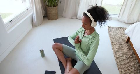 Mindful Meditation: Woman in Green Activewear Practicing Serenity