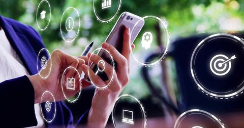 Mid-adult Woman Holding Smartphone Tapping Screen with Augmented Interface at Cafe