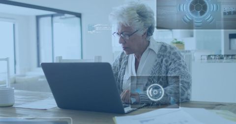 senior businesswoman analyzing data on laptop with virtual interface - Download Free Stock Images Pikwizard.com