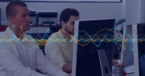 Coworkers Collaborating on Technology with Digital Waveforms Overlay