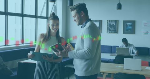 Colleagues Analyzing Data Together in Modern Office Environment