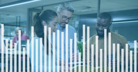 Diverse business team analyzing tablet with bar chart overlay in modern open office data strategy