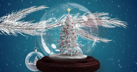 Snowy Christmas Globe with Festive Tree and Falling Snowflakes