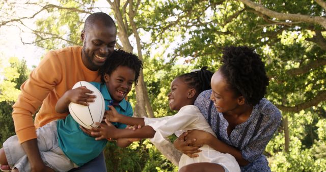 Happy African American Family Playing Outdoors with Rugby Ball - Download Free Stock Images Pikwizard.com