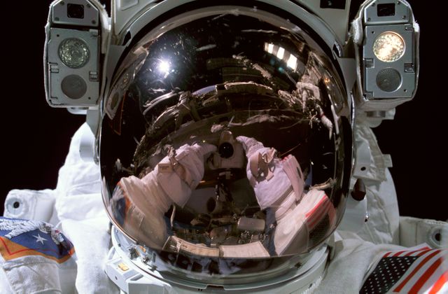 ISS006-344-011 (15 January 2003) --- Astronaut Donald R. Pettit, Expedition 6 NASA ISS science officer, photographs his helmet visor during a session of extravehicular activity (EVA). Pettit&#0146;s arms and camera are visible in the reflection of his helmet visor.  Astronaut Kenneth D. Bowersox, mission commander, is also visible in visor reflection, upper right.