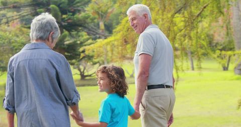 family bonding: grandparents walking with child in park - Download Free Stock Images Pikwizard.com