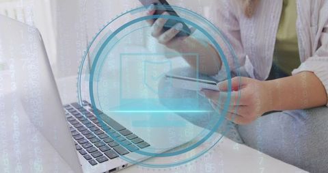 Woman Making Secure Online Payment Using Smartphone and Credit Card Over Laptop
