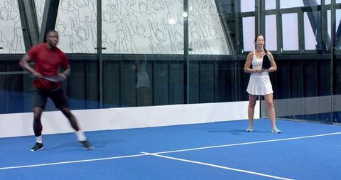 Padel tennis game intensity with diverse players in modern indoor court
