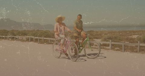 Couple enjoying cycling adventure on coastal pathway