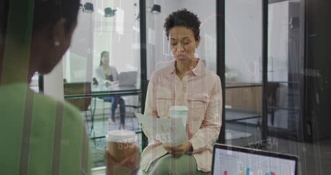 Business Meeting with Financial Data Overlaying Scene