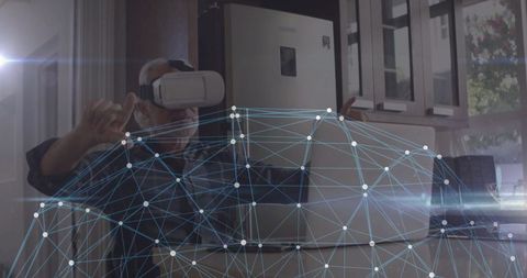 Mature Man in Virtual Reality Manipulating Digital Network in Kitchen