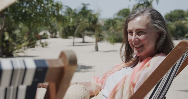 Smiling Senior Woman Relaxing Outdoors on a Sun Lounger - Download Free Stock Images Pikwizard.com