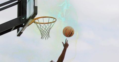 Outdoor Basketball Player Reaching for Rim with Turquoise Motion Trail Closeup