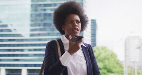 Businesswoman Engaged in Conversation on Smartphone in Urban Setting