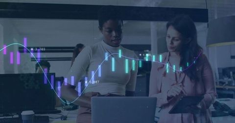 Female Professionals Analyzing Business Analytics in Modern Office