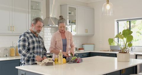 Senior Couple Unpacking Vegetables for a Wholesome Meal