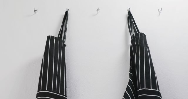 Striped Black and White Aprons Hanging on Wall - Download Free Stock Images Pikwizard.com