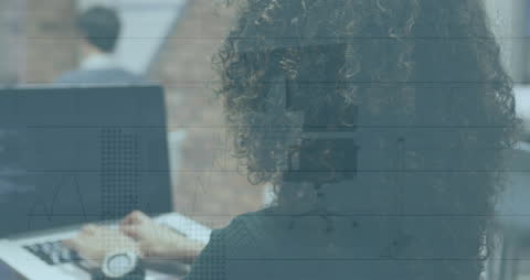 African American Woman Analyzing Data with Overlapping Digital Graphics