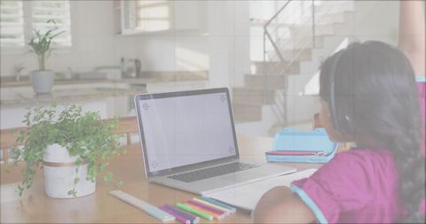 Girl Studying at Home with Laptop in Kitchen Setting