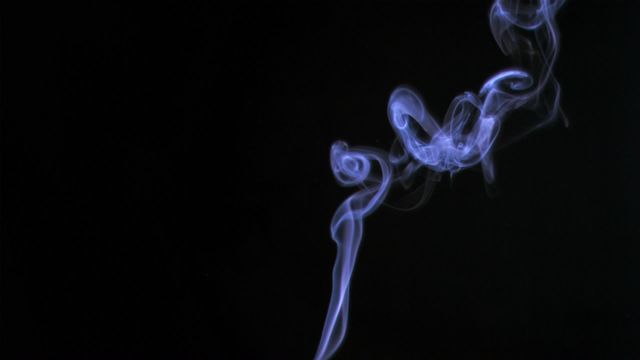 Swirling cigarette smoke adds a sense of mystery and elegance against a black background. Perfect for use in projects related to relaxation, tranquility, meditation, smoking, and backgrounds. Can be used for artistic and dramatic visual effects, advertising campaigns, design backdrops, and illustrations involving peaceful or moody themes.