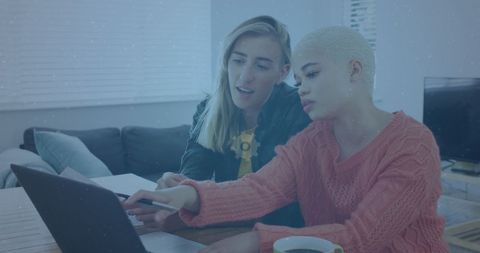 Two Female Friends Collaborating on Laptop at Home