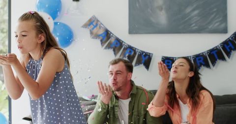 Family Celebrating Birthday with Confetti and Balloons