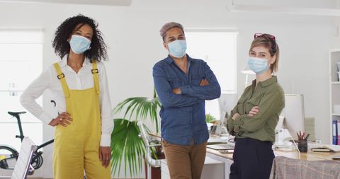 Diverse Team Wearing Masks in Modern Office