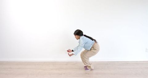 African American Woman Performing Dance Routine in Minimalist Room