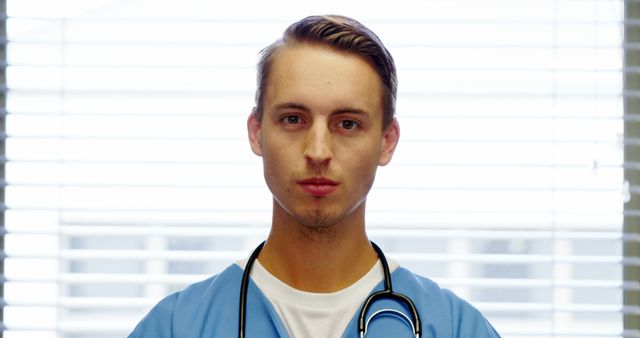 Confident Young Male Doctor Standing in Hospital Room - Download Free Stock Images Pikwizard.com